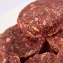 Close up of Beefy Beef raw dog food patties from LUNA & me