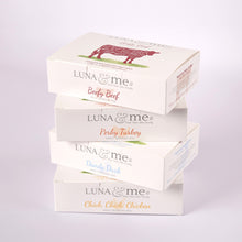 Four stacked boxes filled with LUNA & me raw dog food mince containing beef, turkey, duck, and chicken