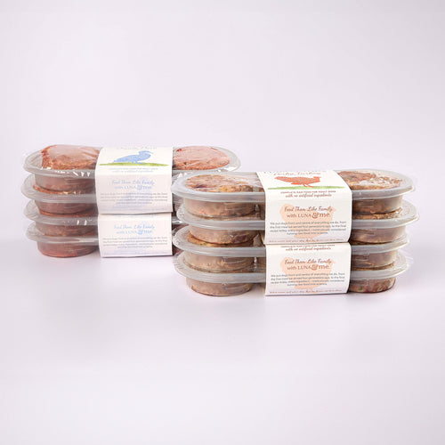 Four stacked plastic containers filled with LUNA & me Weekly Favourites raw dog food patties