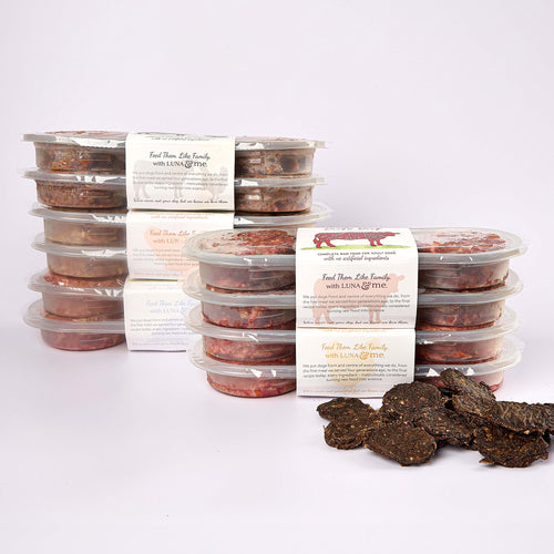 Five stacked plastic containers filled with LUNA & me senior raw dog food patties and loose SuperBlends dog treats