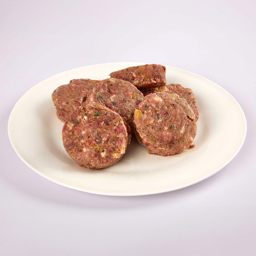 Six SuperBlends Beef & Venison raw dog food patties on a white plate from LUNA & me