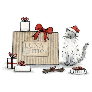 Illustration of a cat - 'Stella' - next to a LUNA & me box and wrapped gifts.